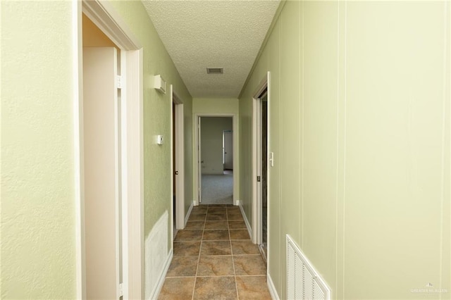 15220 Wilson Rd, Harlingen, TX 78552 - hallway featuring a textured ceiling