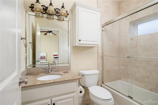 full bathroom with vanity, ceiling fan, toilet, and enclosed tub / shower combo