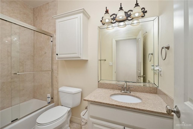 full bathroom featuring vanity, toilet, and combined bath / shower with glass door