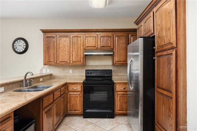 109 W Cora Lee Dr Unit 9, South Padre Island, TX 78597 - kitchen featuring sink, stainless steel fridge, light stone countertops, light tile patterned floors, and black range with electric cooktop