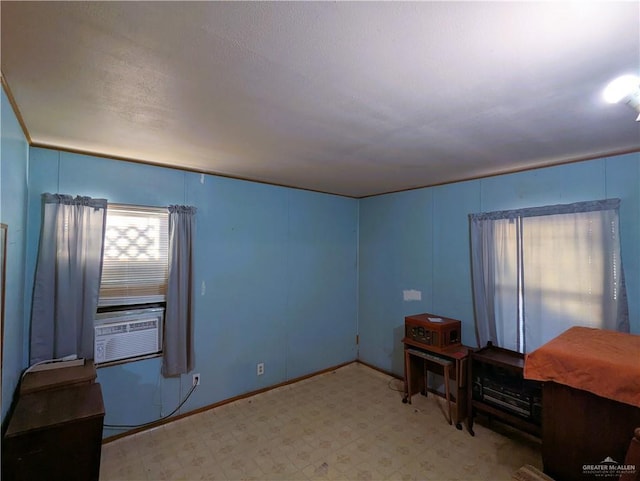 interior space featuring tile patterned floors, cooling unit, and baseboards