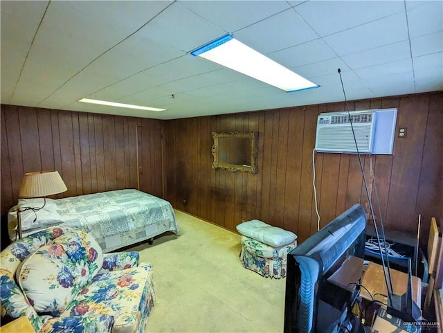 carpeted bedroom featuring wood walls and a wall mounted AC