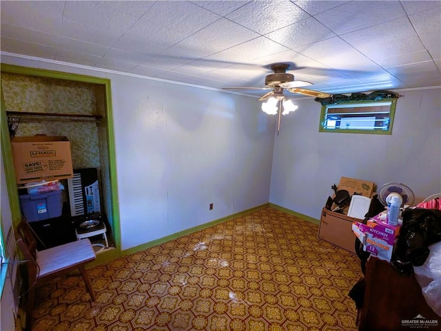 interior space featuring tile patterned floors, baseboards, and ceiling fan