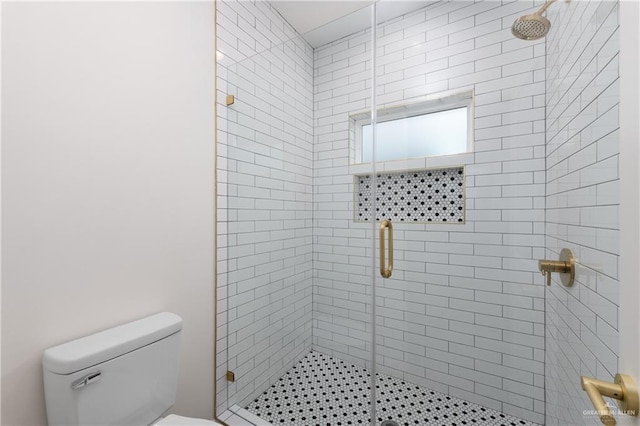 bathroom featuring toilet and walk in shower