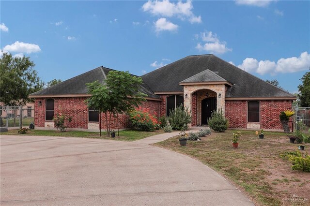 1617 N Monmack Rd, Edinburg, TX 78541 - view of front of home with brick siding and a shingled roof