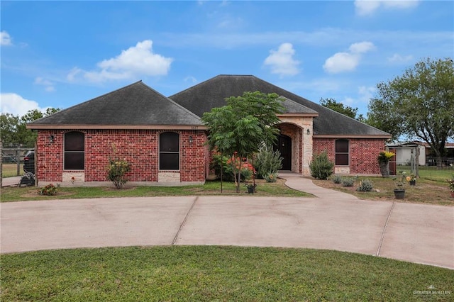 1617 N Monmack Rd, Edinburg, TX 78541 - single story home featuring brick siding, roof with shingles, and a front lawn