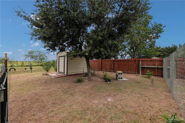 1617 N Monmack Rd, Edinburg, TX 78541 - fenced backyard featuring a storage unit