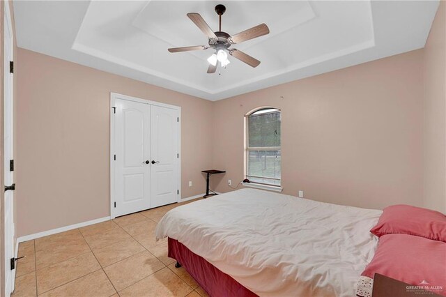 1617 N Monmack Rd, Edinburg, TX 78541 - bedroom with a tray ceiling, light tile patterned flooring, a closet, and ceiling fan