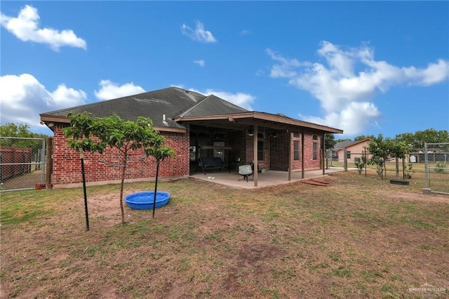 1617 N Monmack Rd, Edinburg, TX 78541 - back of house featuring a patio area, a gate, and brick siding