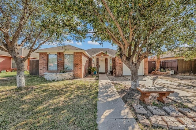 view of front facade with a front yard, fence, driveway, an attached garage, and brick siding