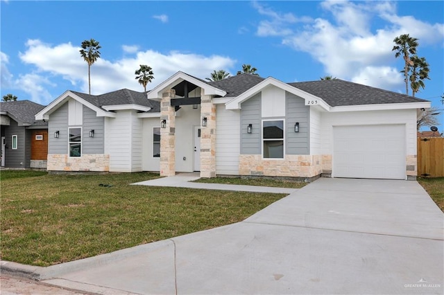 view of front of home with a garage and a yard