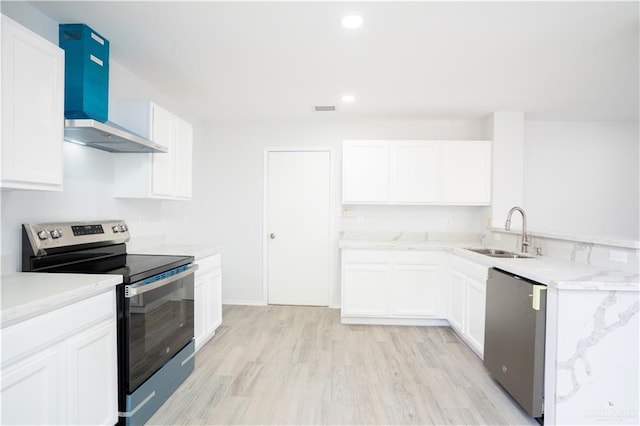 kitchen featuring appliances with stainless steel finishes, wall chimney exhaust hood, sink, light hardwood / wood-style floors, and white cabinetry