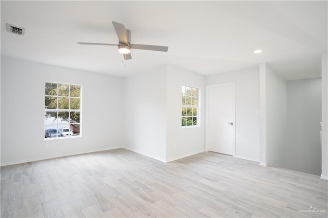 spare room with light wood-type flooring and ceiling fan