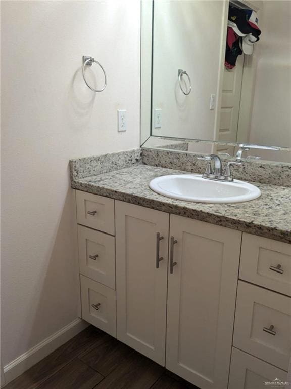 bathroom featuring vanity and wood-type flooring