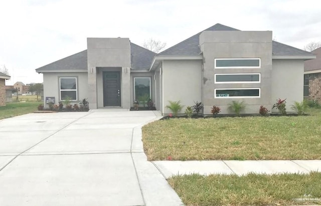 modern home featuring a front yard