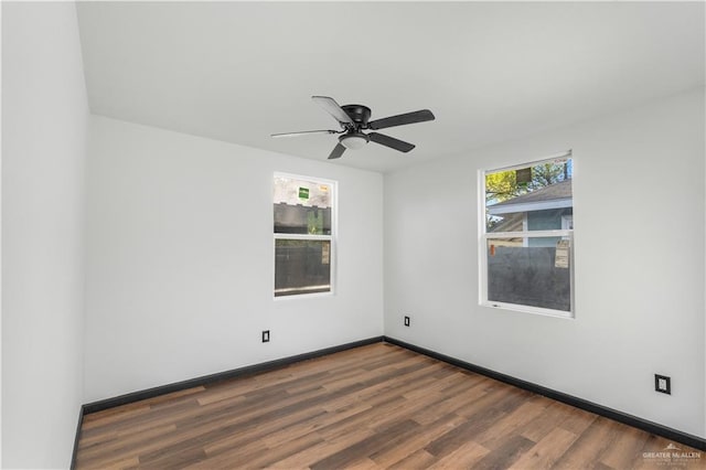 empty room featuring baseboards, a ceiling fan, and wood finished floors