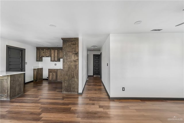 interior space with visible vents, baseboards, and wood finished floors