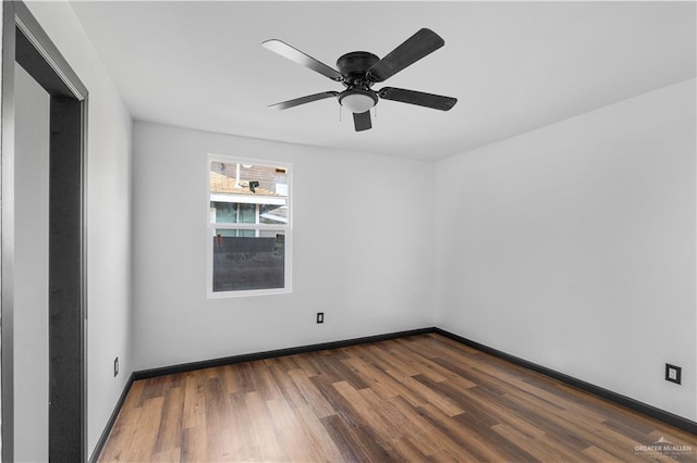 unfurnished room with baseboards, ceiling fan, and wood finished floors