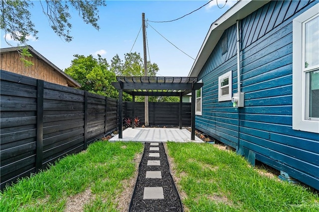 view of yard with a patio, a fenced backyard, and a pergola