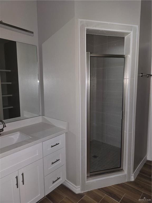 2604 Israel Ave, Alton, TX 78573 - full bath featuring wood finish floors, vanity, a stall shower, and baseboards