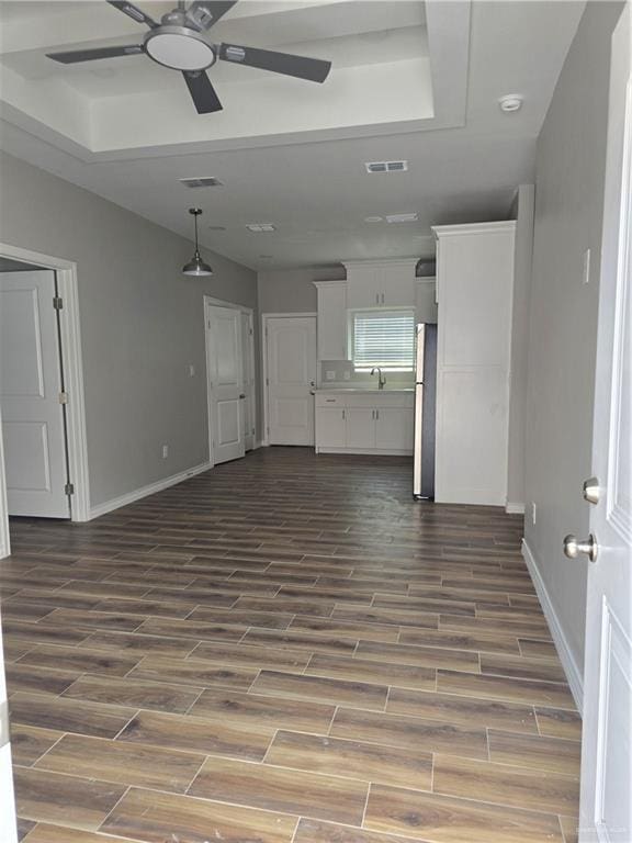 2604 Israel Ave, Alton, TX 78573 - unfurnished living room featuring a ceiling fan, dark wood-style flooring, baseboards, and a sink