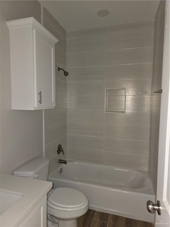 2604 Israel Ave, Alton, TX 78573 - full bathroom featuring vanity, bathtub / shower combination, toilet, and wood finished floors
