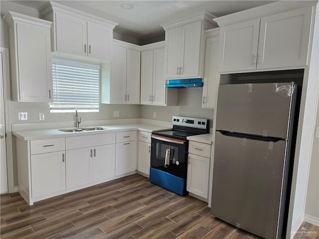 2604 Israel Ave, Alton, TX 78573 - kitchen with freestanding refrigerator, range with electric cooktop, a sink, under cabinet range hood, and dark wood-style flooring