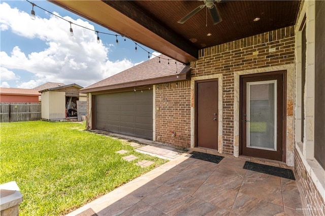 property entrance featuring ceiling fan, a yard, and a garage