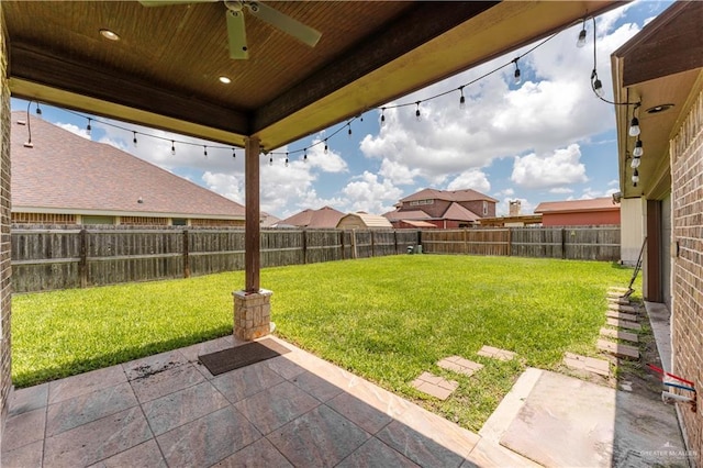 view of yard with a patio and ceiling fan