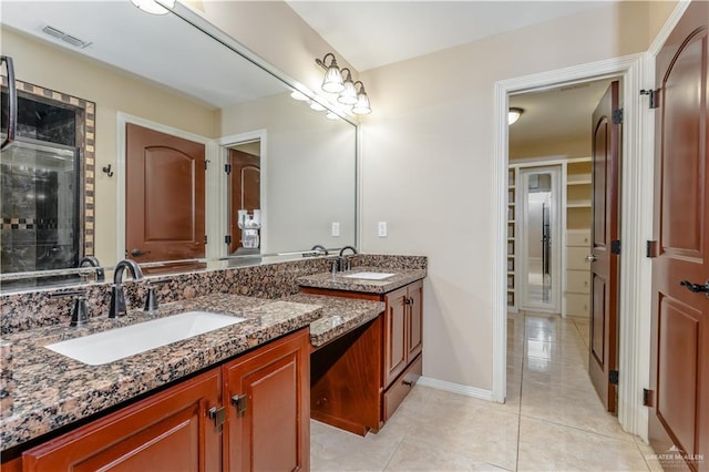 bathroom with vanity, tile patterned floors, and walk in shower