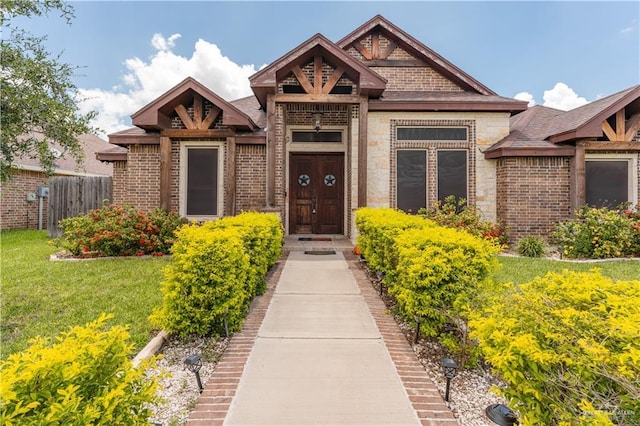 doorway to property featuring a lawn