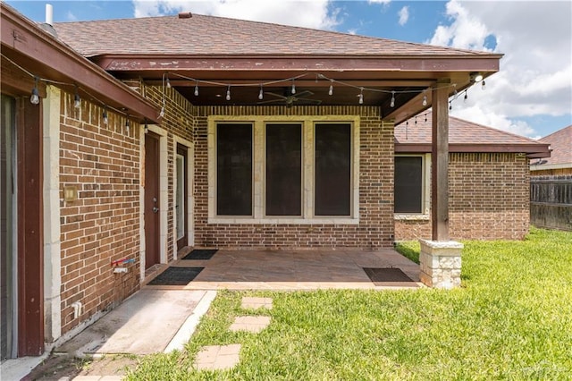 back of house with ceiling fan, a yard, and a patio