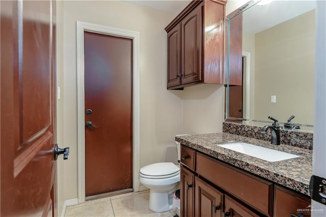 bathroom featuring vanity, toilet, and tile patterned flooring