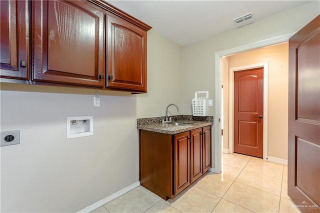 laundry room with sink, cabinets, light tile patterned floors, hookup for a washing machine, and electric dryer hookup