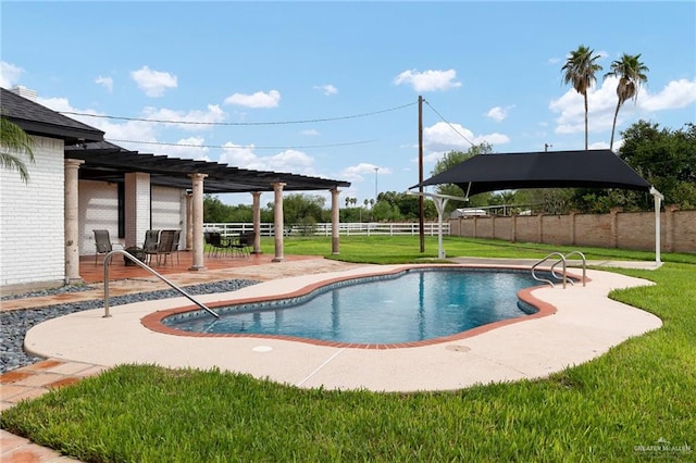 view of swimming pool with a patio area and a lawn