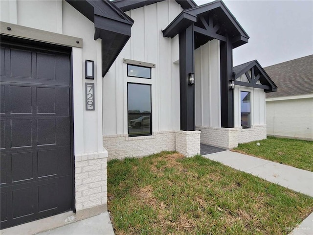 entrance to property with a yard and a garage