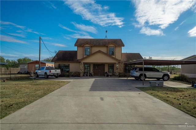 traditional-style home featuring a carport, driveway, and a front lawn