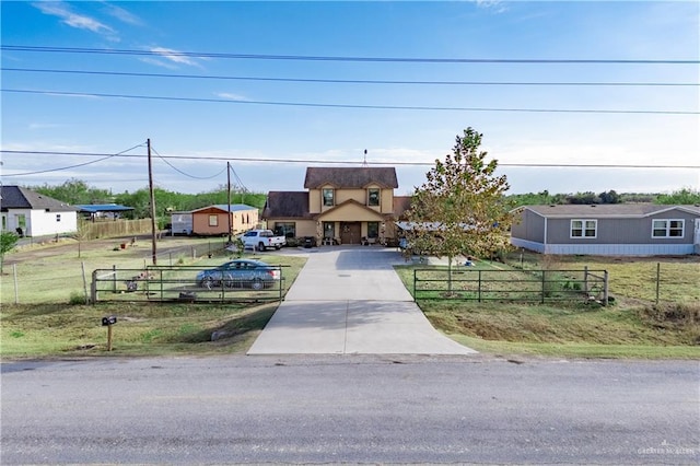 view of front of home with driveway and a fenced front yard