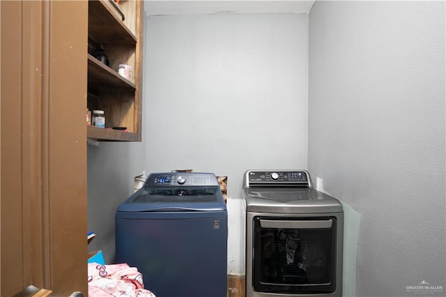 clothes washing area with laundry area and separate washer and dryer