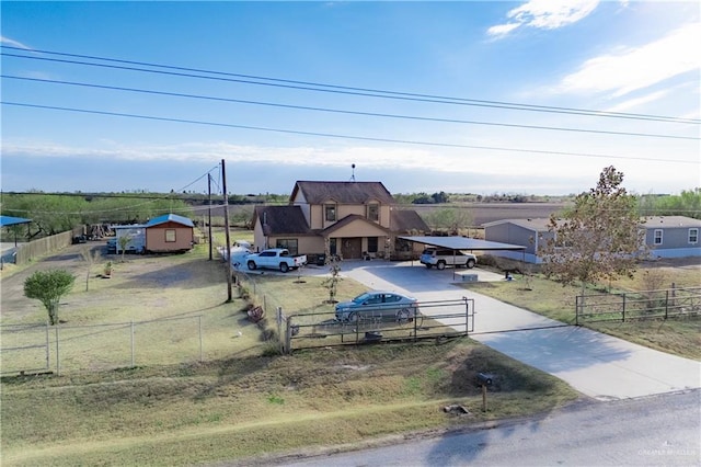 view of front of house with a rural view, fence, and a gate