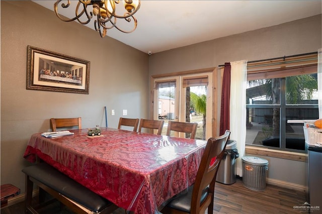 dining area with a notable chandelier, baseboards, and wood finished floors