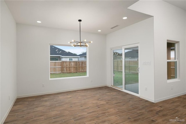 9218 N 25th Ln, Mcallen, TX 78504 - unfurnished room featuring a chandelier, wood finished floors, recessed lighting, and baseboards