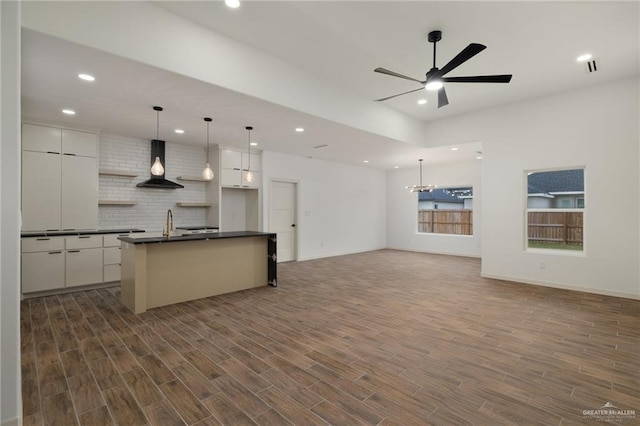 9218 N 25th Ln, Mcallen, TX 78504 - kitchen with wall chimney exhaust hood, dark countertops, recessed lighting, ceiling fan, and tasteful backsplash
