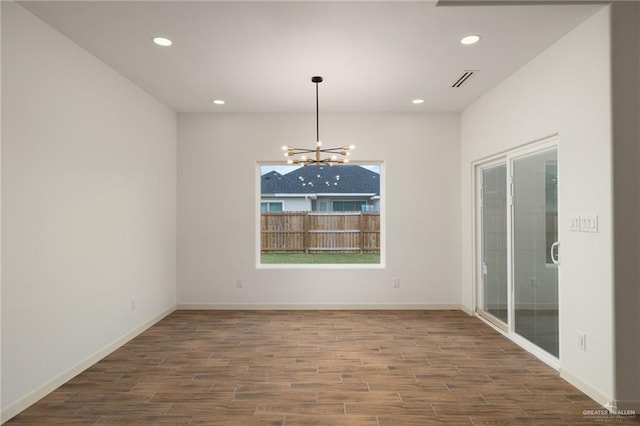 9218 N 25th Ln, Mcallen, TX 78504 - spare room with wood finished floors, a chandelier, recessed lighting, and baseboards