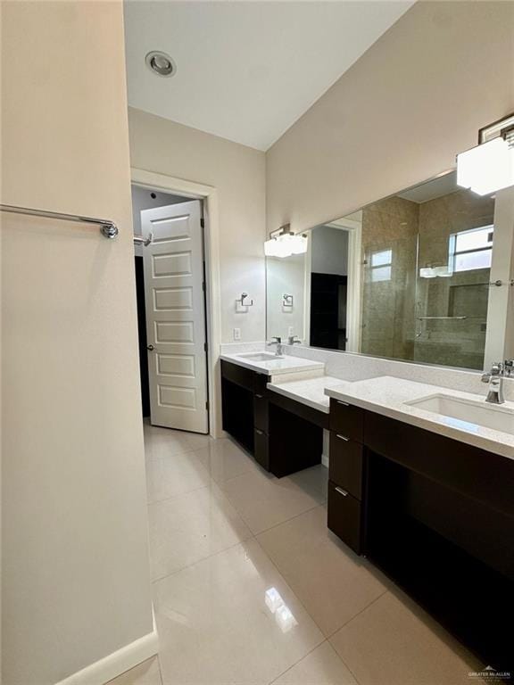 bathroom featuring tile patterned floors, a shower with door, and vanity