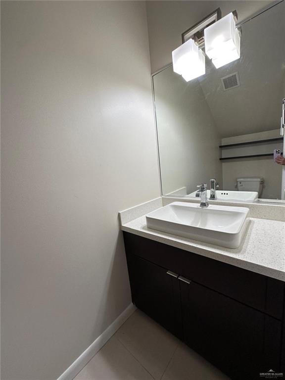 bathroom with tile patterned floors, vanity, and toilet