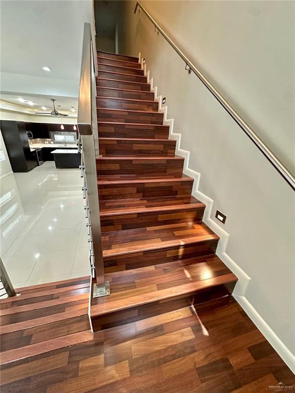 stairs with hardwood / wood-style flooring