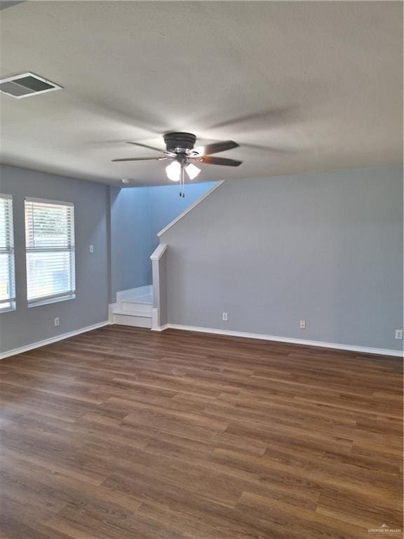 interior space with ceiling fan and dark wood-type flooring