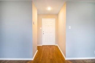 hall with hardwood / wood-style flooring