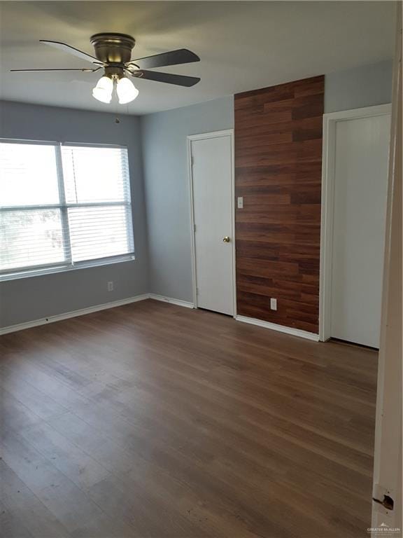 empty room featuring ceiling fan and hardwood / wood-style flooring